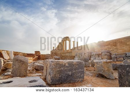 Greece. Rhodes. Acropolis of Lindos. Doric columns of the ancient Temple of Athena Lindia the IV century BC and the bay of St. Paul