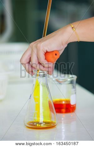 researcher working in a biotechnology lab / biochemical engineer working with microplate in a laboratory experiment