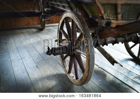 Old wooden wagon wheel. Retro photo. Brown old wheel