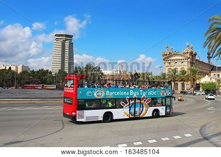 BARCELONA, SPAIN - OCTOBER 8, 2013: Barcelona Bus Touristic. 3 routes with 1 ticket. Open-top double decker bus. Audioguide in 10 languages