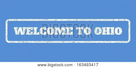 White rubber seal stamp with Welcome To Ohio text. Vector message inside rounded rectangular frame. Grunge design and scratched texture for watermark labels. Horisontal emblem on a blue background.