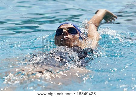 A young woman swimming in the pool Selecitve focus and small depth of field