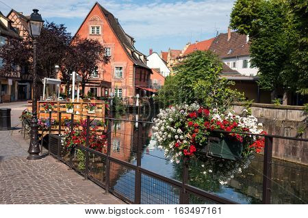 The old half-timbered houses stand along the canal. Summer morning.