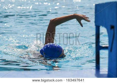 A young woman swimming in the pool Selecitve focus and small depth of field