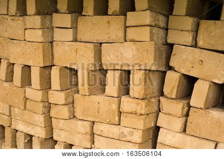 Stack of raw bricks drying in the open air.
