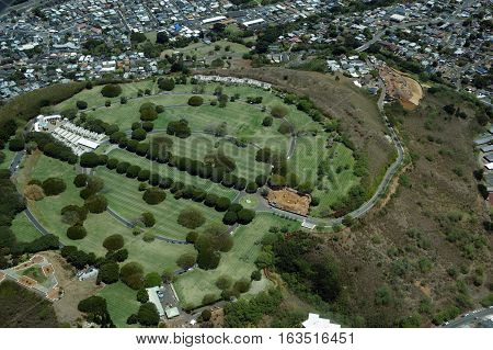 Aerial view of Punchbowl Cemetery or the National Memorial Cemetery of the Pacific with parts under construction which is visited by millions of tourist and island locals every year on the tropical island of Oahu in Honolulu Hawaii USA.
