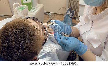 Woman at the dentist clinic office gets dental medical examination and treatment. Odontic and mouth health is important part of modern human life that dentistry help with.