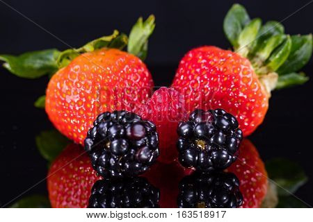 Assorted berries isolated on a black background