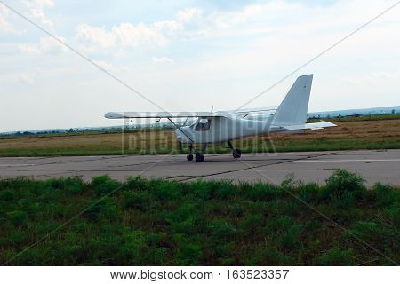 Small sport aircraft on the runway at the airport.