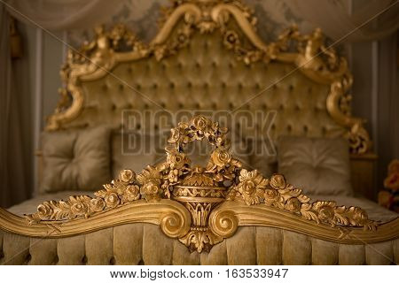 Beautiful royal and classical living room interior with a large bed in expensive apartment. Interior of classic style bedroom in luxury villa. Royalty concept.