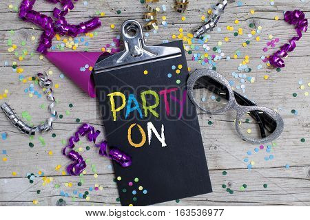 many colorful carnival confetti on wood background