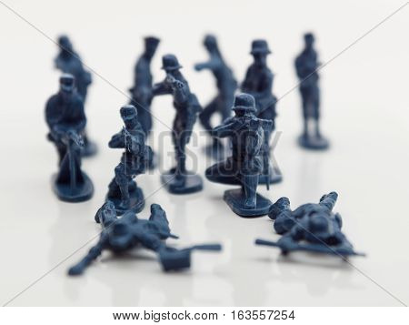 Small plastic toy soldiers on white background