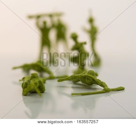 Small plastic toy soldiers on white background