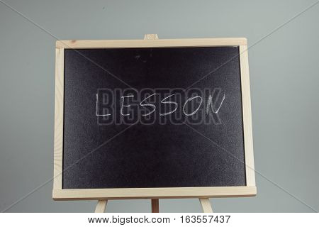Lesson Written In White Chalk On A Black Chalkboard
