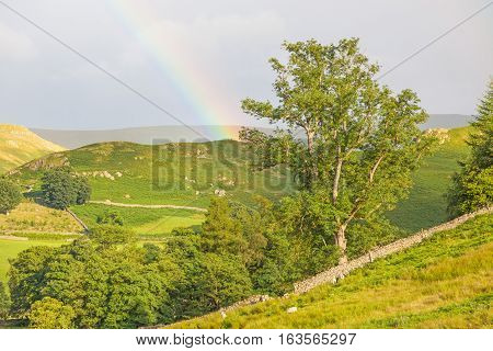 Rainbow landscape near Pooley Bridge, in the Ullswater area of the Lake District in England.