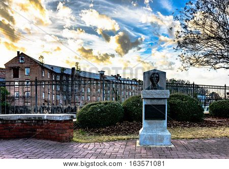Prattville Alabama USA - December 36 2016: Bust of Daniel Pratt founder of Prattville in Heritage Park overlooking Autauga Creek and Continental Eagle Cotton Gin Company.