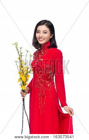 Portrait Of A Beautiful Asian Woman On Traditional Festival Costume Ao Dai Holding Hoa Mai Tree (och