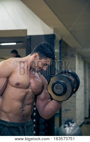 strong young man trains hands in gim