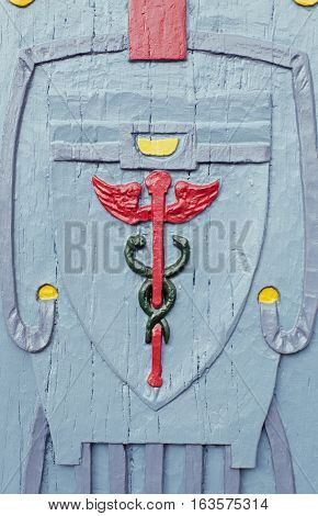 Wooden relief Aesculapius, background, close up, detail