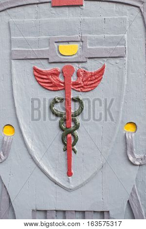 Wooden relief Aesculapius, background, close up, detail