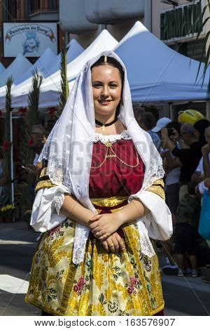SELARGIUS, ITALY - September 11, 2016: Former marriage Selargino - Sardinia - detail of a beautiful smiling girl in traditional Sardinian costume