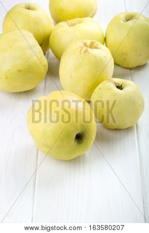 Ripe Antonovka apples on white wooden table