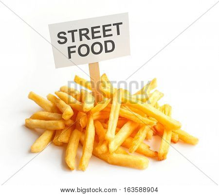 Pile of potato fries on kraft paper. Poor street food, obesity, heart disease. French fries with a sign, Empty copy space for text
