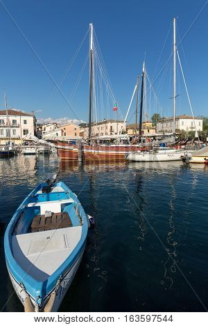 BARDOLINO ITALY - MAY 4 2016: Sailboats and fishing boats at Porto di Bardolino harbor on The Garda Lake . Italy