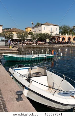 BARDOLINO ITALY - MAY 4 2016: Fishing boats at Porto di Bardolino harbor on The Garda Lake . Italy