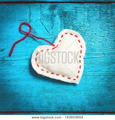 Valentine's Day. Colorful knitted hearts. White heart on the blue boards. Valentines day. Heart pendant. Red heart. Valentine cards. Space for text. Eighth of March. International Women's Day.
