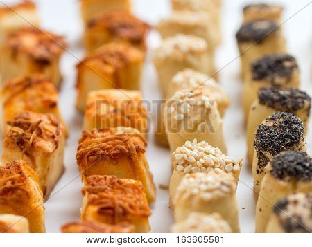 Couple of salty party snacks standing in a row.