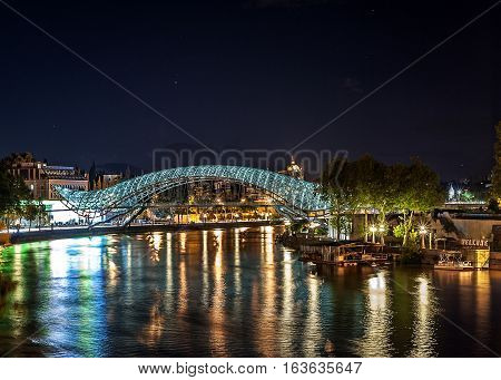 Georgia, Tbilisi night . View from the square Gorgasali at the Kura, Peace Bridge , Anchiskhati Basilica .