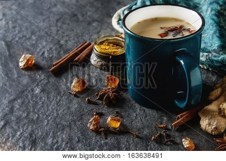 Traditional Indian Masala Tea In Ceramic Cup With Spices To Milk