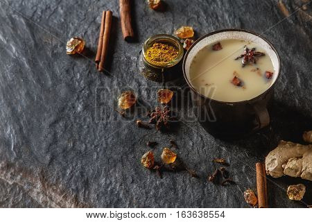 Traditional Indian Masala Tea In Ceramic Cup With Spices To Milk
