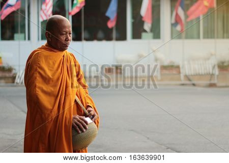 Monk Is Given Food And Lotus From Buddhist . Selective Focus.