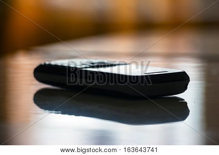 Old mobile phone with buttons is on the table
