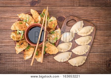 Homemade asian сhicken potstickers with soy sauce.