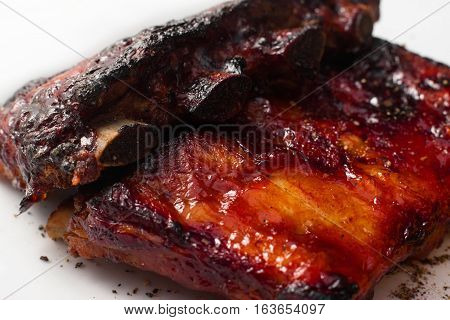 Hot appetizing bbq ribs closeup. Just prepared pork meat. American traditional cuisine, homemade cuisine, junk food concept