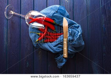 red chili pepper on the wood blue table with the shawl