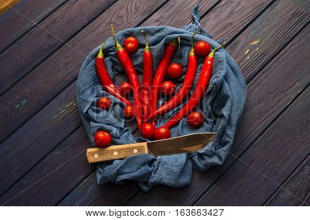 red chili pepper on the wood blue table with the shawl