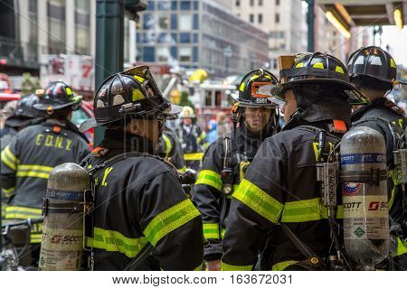 New York, United States of America - November 20, 2016: Group of firemen waiting in front of the  Grand Central Market in Manhattan