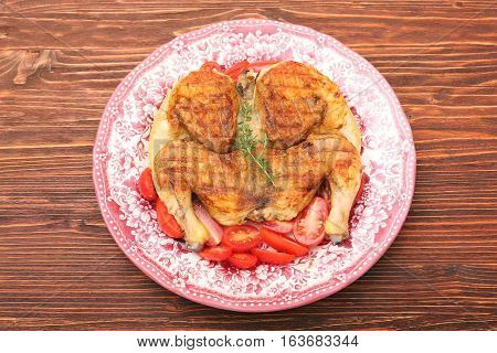 Grilled chicken Tabaka on wooden table. Georgian cuisine