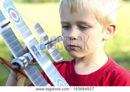 Child young boy and his RC plane toy