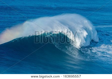 A huge wave breaking in Nazare Portugal.