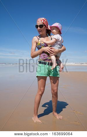 Mum With Baby Looking At Beach