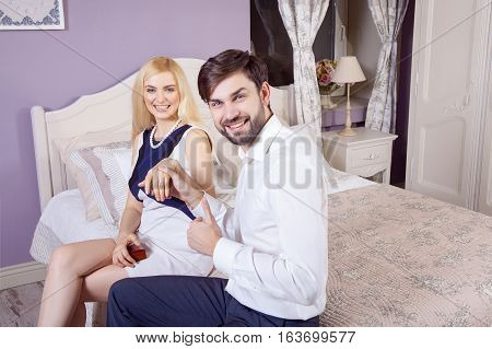 Handsome man doing a marriage proposal while offering his wife an engagement ring. Boyfriend make a marriage proposal to his girlfriend in valentine days.