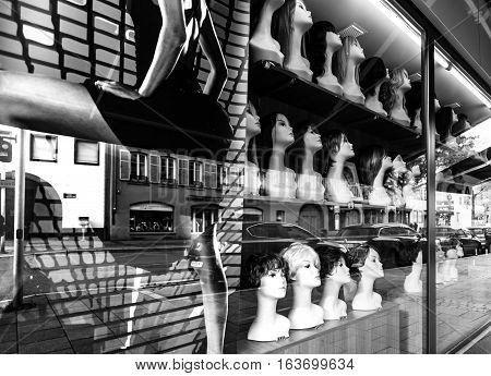 Shop-window With Mannequin Heads And Different Hair-dressing