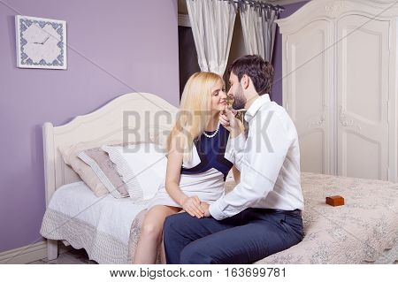 Handsome man doing a marriage proposal while offering his wife an engagement ring. Boyfriend make a marriage proposal to his girlfriend in valentine days.
