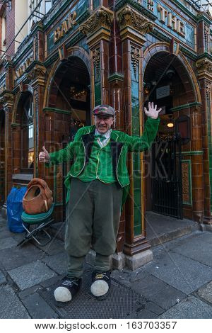 Dublin, Ireland - 2 Jan 2017: Temple Bar historic district., Dublin, Ireland. Man in Irish traditional clothes performing on the street at The Quays Bar