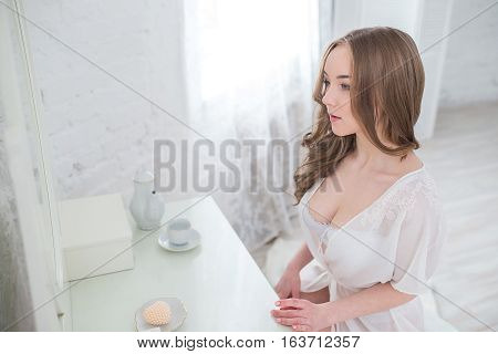 Portrait of sexy young woman in lingerie in white Studio.